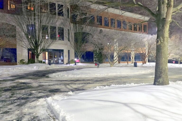 Snow-covered building entrance at night