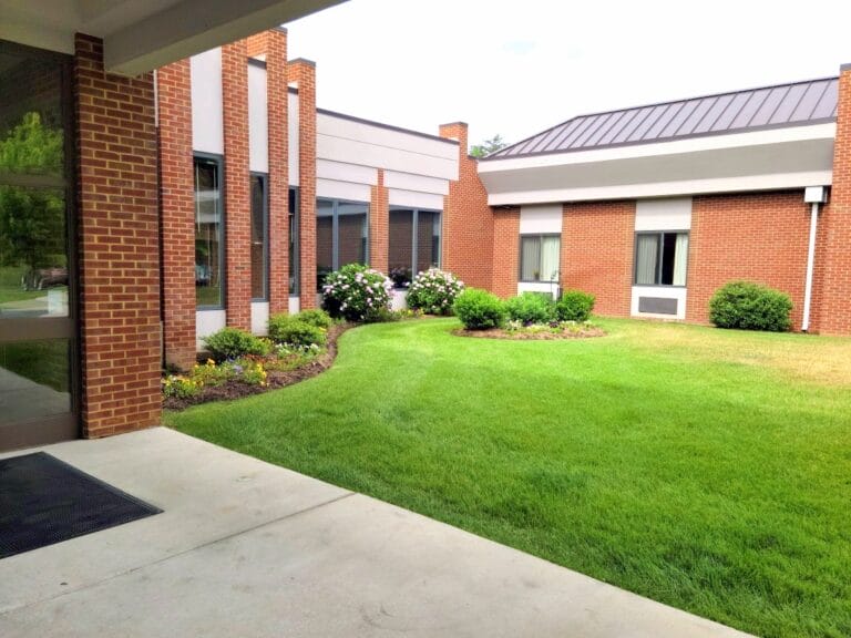 Brick building with green lawn and shrubs