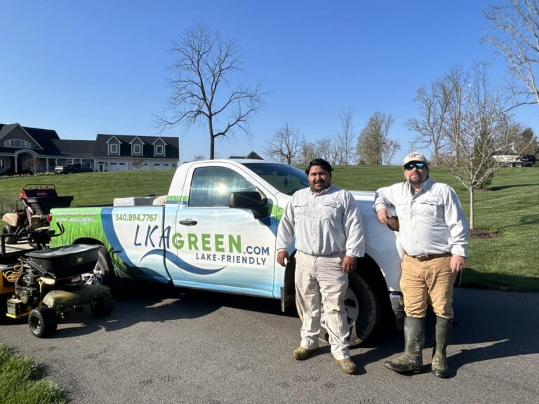 Lawn care team beside their truck on sunny day