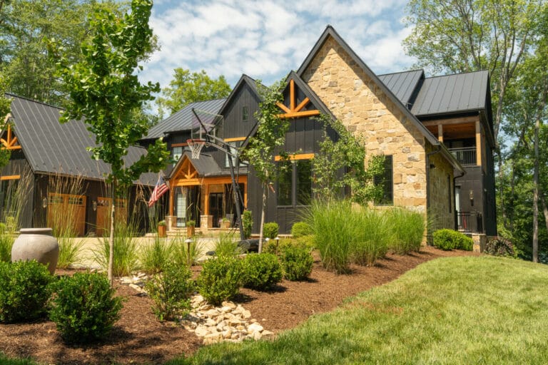 Modern farmhouse with stone facade and landscaped yard