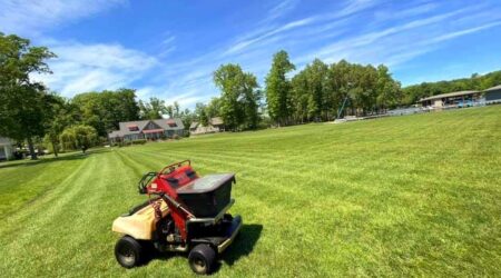 Lawn mower on a large grassy field