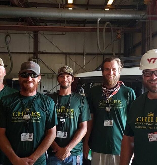 Five men in green Chiles Enterprises shirts
